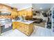 Kitchen with wooden cabinetry, stainless steel appliances, and tile countertops at 6445 W Windsor Blvd, Glendale, AZ 85301