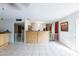 Spacious living room with a half-wall, tile flooring, and sliding glass doors at 6445 W Windsor Blvd, Glendale, AZ 85301