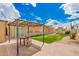 Outdoor space featuring an artificial grass lawn, shed, covered patio, and brick pavers at 6908 W Sunnyside Dr, Peoria, AZ 85345