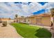 Spacious backyard features artificial turf, gravel accents, and a charming brick fireplace at 6908 W Sunnyside Dr, Peoria, AZ 85345
