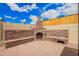 Relaxing outdoor space featuring a brick fireplace, benches, and a paved patio at 6908 W Sunnyside Dr, Peoria, AZ 85345