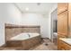 Bright bathroom features a soaking tub with decorative tile surround at 6908 W Sunnyside Dr, Peoria, AZ 85345