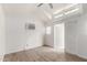 Well-lit bedroom with wood-look floors, an AC unit, and a sliding glass door at 6908 W Sunnyside Dr, Peoria, AZ 85345