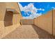 Gated driveway with gravel and an awning for covered parking or storage at 6908 W Sunnyside Dr, Peoria, AZ 85345