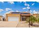 Inviting single-story home boasts solar panels, a two-car garage, and low-maintenance desert landscaping at 6908 W Sunnyside Dr, Peoria, AZ 85345