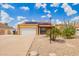 Charming single-story home with solar panels, a two-car garage, and low-maintenance desert landscaping at 6908 W Sunnyside Dr, Peoria, AZ 85345