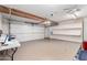 Spacious garage with epoxy floors, pegboard walls, and overhead storage at 6908 W Sunnyside Dr, Peoria, AZ 85345