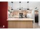 Kitchen with wooden cabinets, an island, and stainless steel appliances provides a functional cooking space at 6908 W Sunnyside Dr, Peoria, AZ 85345