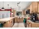 Bright kitchen with wood cabinets, dark appliances, and access to outdoor space offers modern appeal at 6908 W Sunnyside Dr, Peoria, AZ 85345