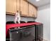 Functional laundry room with modern washer and dryer and ample cabinet space at 6908 W Sunnyside Dr, Peoria, AZ 85345