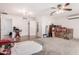Large living room with hardwood flooring, carpet, and ceiling fan, offering plenty of room at 6908 W Sunnyside Dr, Peoria, AZ 85345