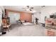 Bright living room with carpet and hardwood flooring, featuring sliding doors and ample space at 6908 W Sunnyside Dr, Peoria, AZ 85345