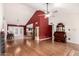 Spacious living room with hardwood floors, vaulted ceilings, and seamlessly connects to the kitchen at 6908 W Sunnyside Dr, Peoria, AZ 85345