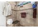 Modern shower features tan tile, a built-in bench, and decorative trim at 6908 W Sunnyside Dr, Peoria, AZ 85345