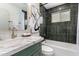 Stylish bathroom features dark tiled walls, marble countertop, and modern fixtures at 7125 N 23Rd Ave, Phoenix, AZ 85021