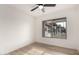 Bright bedroom featuring neutral walls, ceiling fan, and wood-look flooring at 7125 N 23Rd Ave, Phoenix, AZ 85021