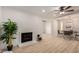 Open living space boasts a charming fireplace, hardwood floors, and dining area at 7125 N 23Rd Ave, Phoenix, AZ 85021