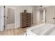 Bedroom features a wood dresser, wood floors, and an open door at 7125 N 23Rd Ave, Phoenix, AZ 85021