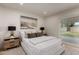 Well-lit bedroom features a neutral color palette, wood floors, and an exterior door at 7125 N 23Rd Ave, Phoenix, AZ 85021
