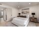 Well-lit bedroom features a neutral color palette, wood floors, and an exterior door at 7125 N 23Rd Ave, Phoenix, AZ 85021