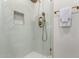 Updated shower stall with glass door, brass fixtures, and white tile at 7125 N 23Rd Ave, Phoenix, AZ 85021