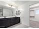 Bathroom featuring dual sinks, tile floors, and a doorway to a walk in closet at 7342 S Debra Dr, Gilbert, AZ 85298