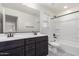 Bathroom with a dual sink vanity, a large mirror, and a shower-tub combo at 7342 S Debra Dr, Gilbert, AZ 85298