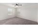Neutral bedroom with plush carpet, two windows, and a ceiling fan for added comfort at 7342 S Debra Dr, Gilbert, AZ 85298