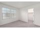 Neutral bedroom with plush carpet, two windows that provide natural light, and access to a walk-in closet at 7342 S Debra Dr, Gilbert, AZ 85298