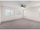 Bedroom featuring carpeted floors and white walls with a ceiling fan and multiple windows at 7342 S Debra Dr, Gilbert, AZ 85298