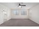 Bedroom featuring carpeted floors and white walls with a ceiling fan and multiple windows at 7342 S Debra Dr, Gilbert, AZ 85298