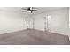 Bedroom featuring carpeted floors and white walls with a ceiling fan and doorways at 7342 S Debra Dr, Gilbert, AZ 85298