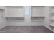 Walk in closet featuring carpeted floors, white walls, and custom shelves at 7342 S Debra Dr, Gilbert, AZ 85298