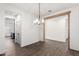 Open-concept dining room with wood beam entryway and modern chandelier at 7342 S Debra Dr, Gilbert, AZ 85298