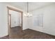 Dining area featuring modern chandelier and wood beam entryway at 7342 S Debra Dr, Gilbert, AZ 85298
