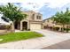 Charming two-story home with a well-manicured lawn and a spacious two-car garage at 7342 S Debra Dr, Gilbert, AZ 85298