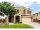 Charming two-story home with a well-manicured lawn and a spacious two-car garage at 7342 S Debra Dr, Gilbert, AZ 85298