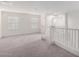 Upstairs hallway with carpeted floors and white walls, featuring a staircase at 7342 S Debra Dr, Gilbert, AZ 85298