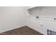 Compact laundry room with wood-look flooring, electrical outlets, and a shelf for storage at 7342 S Debra Dr, Gilbert, AZ 85298
