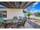 Back patio with a table, chairs, rock garden, and a covered pergola creating an inviting outdoor space at 7949 W Pershing Ave, Peoria, AZ 85381