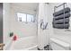 Well-lit bathroom showcasing a tub with shower curtain, towels, and modern fixtures at 7949 W Pershing Ave, Peoria, AZ 85381