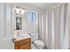 Well-lit bathroom with a single sink vanity, framed mirror, and shower/tub combo with window at 7949 W Pershing Ave, Peoria, AZ 85381