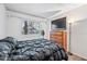 Bedroom features neutral walls, dark bedding, dresser, lamp, and window at 7949 W Pershing Ave, Peoria, AZ 85381