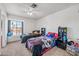 Bright bedroom featuring two beds, a window and decorative furniture at 7949 W Pershing Ave, Peoria, AZ 85381