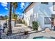 View of the home's side and backyard with palm trees and desert landscaping at 7949 W Pershing Ave, Peoria, AZ 85381