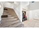 Bright foyer features high ceilings, a staircase, and a tiled floor at 7949 W Pershing Ave, Peoria, AZ 85381