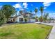 Beautiful two-story home with lush green lawn, mature trees, and a cozy covered patio at 7949 W Pershing Ave, Peoria, AZ 85381