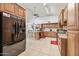 Spacious kitchen with a large island, stainless steel refrigerator, and modern appliances at 7949 W Pershing Ave, Peoria, AZ 85381