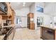Bright, open kitchen featuring granite countertops, black appliances, and tile flooring at 7949 W Pershing Ave, Peoria, AZ 85381