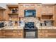 Close-up shot of kitchen featuring black appliances, tiled backsplash, and wooden cabinets at 7949 W Pershing Ave, Peoria, AZ 85381